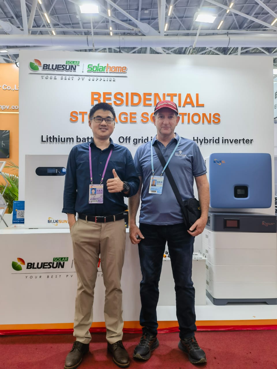 Chris Peo with a solar manufacturer representative at their inverter and battery stand